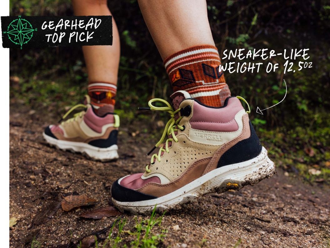 A person walks on a trail wearing pink and leathery boots. Text overlay reads: Gearhead Top Pick, sneaker-like weight of 12.5oz.
